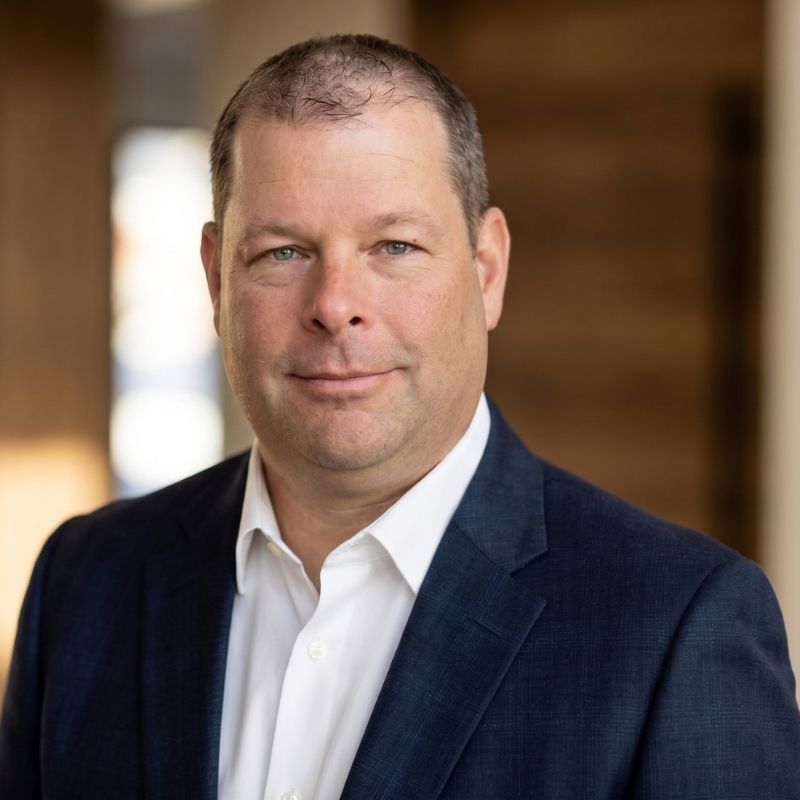 Portrait of Derek Bryer in a navy jacket and white shirt